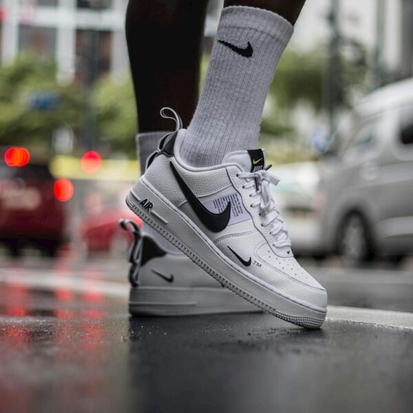 Nike Air Force 1 sneakers on a wet street in Manila, capturing urban street fashion.